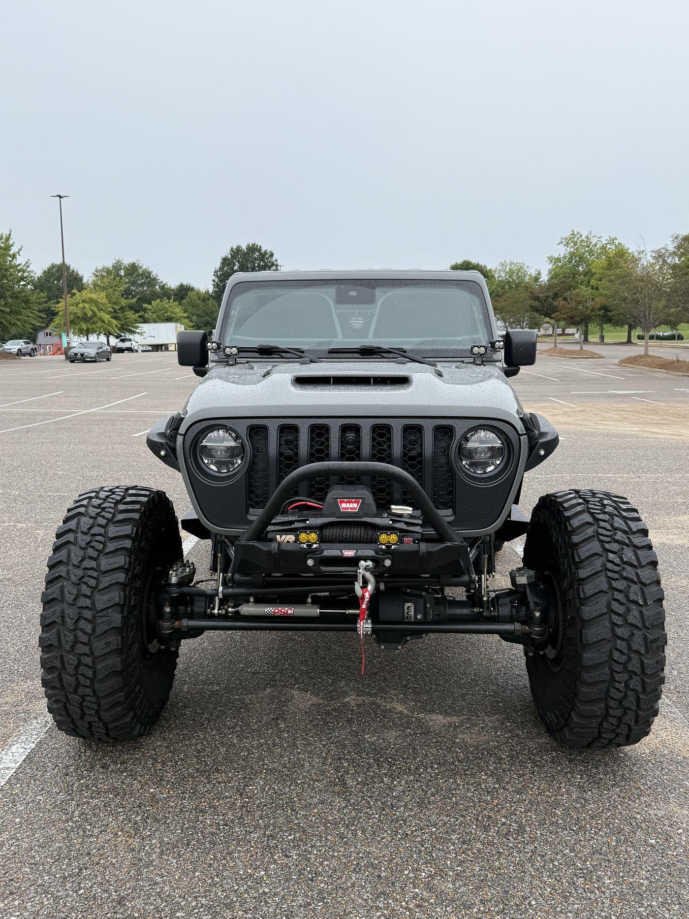 Front view in wet conditions showing full front axle and steering