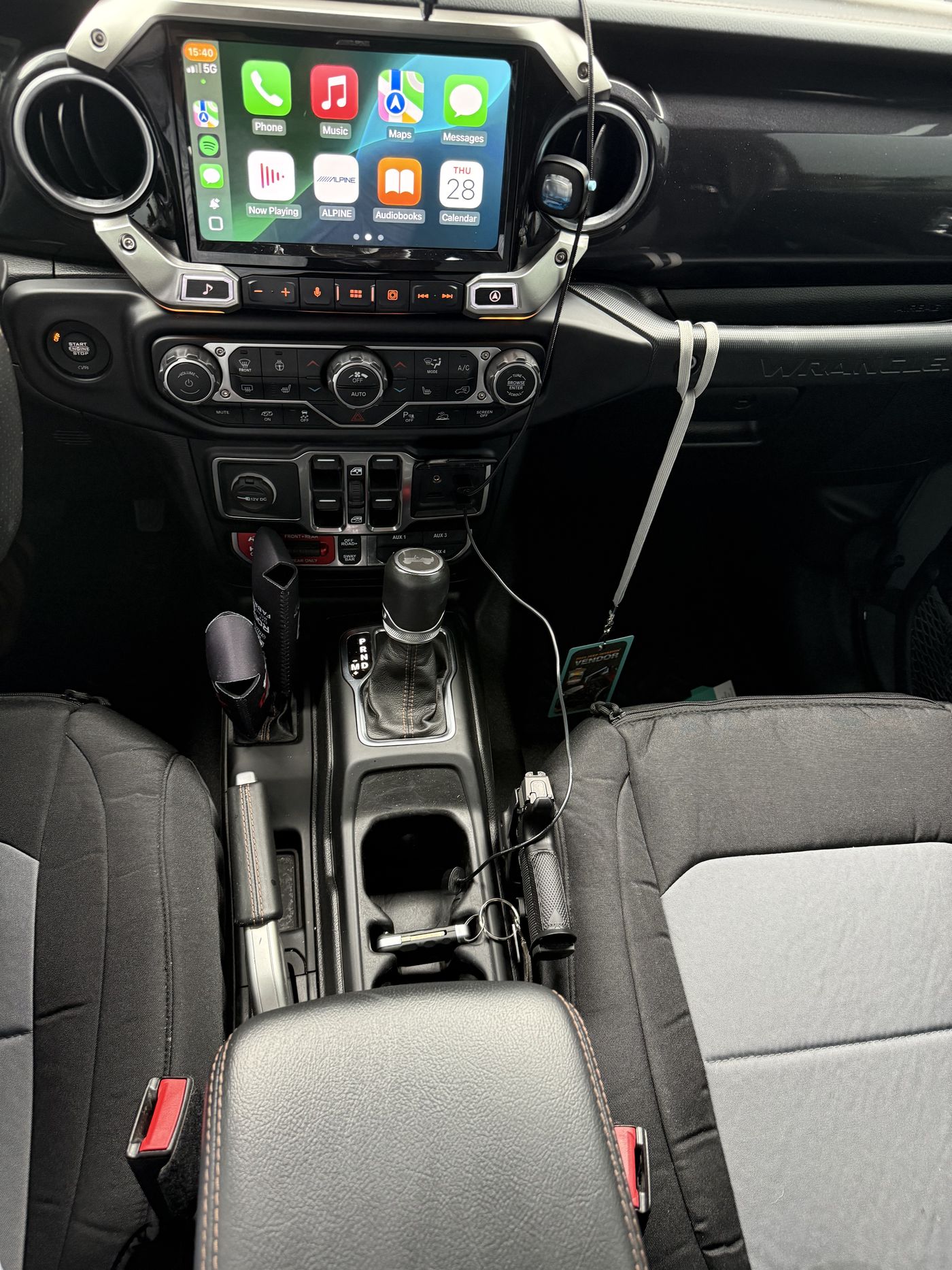 Center console view showing Alpine head unit, climate controls, Atlas transfer case shifters, and 8HP75 auto shifter