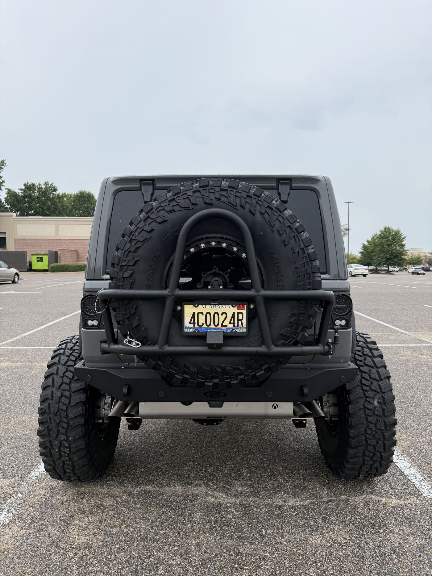Rear view showing the GenRight bumper, tire carrier, and 42 inch Baja Boss spare